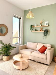 a living room with a couch and a table at Flamingo Suite in Atlit