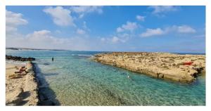 a group of people in the water at a beach at Flamingo Suite in Atlit