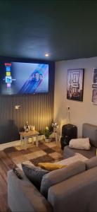 a living room with a couch and a flat screen tv at Atlantic Coast Lodge in Spanish Point