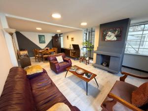 a living room with a couch and a fireplace at St. Gallen Haus in Quito
