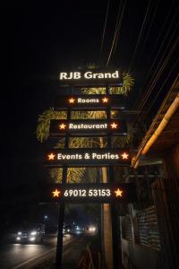 a sign for a rued grand restaurant at night at RJB Grand in Guwahati