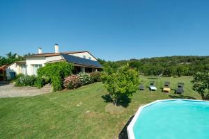 a house with a swimming pool in the yard at Le Petit Paradis in Labastide-de-Virac