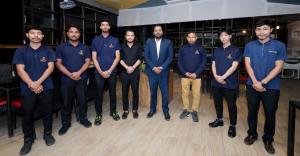 a group of men in blue shirts posing for a picture at RJB Grand in Guwahati