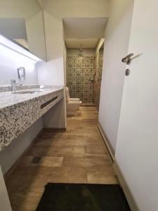 a bathroom with a toilet and a sink and a door at Espacios Plaza VM in Villa María +17 photos