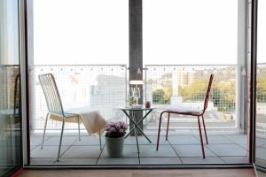 two chairs and a table on a balcony at Laya Living Lucerne - Kriens in Lucerne