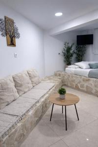a living room with a couch and a table at Olive tree studio ,Corfu Town in Ágios Rókkos