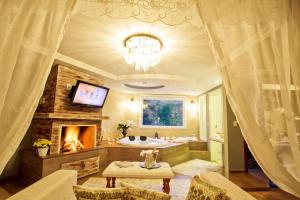 a bathroom with a tub and a fireplace and a television at La vanguardia by Don Ramon Hotel Boutique & Spa in Canela