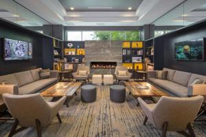a living room with couches and a fireplace at The Summit Hotel in Cincinnati