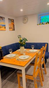 a wooden table with two chairs and a dining room at Merys Home in Günzburg