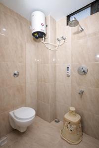 a bathroom with a toilet and a shower at Orchid Palace in Gauhāti +36 photos