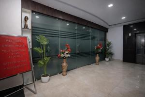 a room with three vases with flowers in it at Orchid Palace in Gauhāti