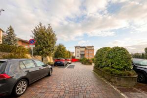 a group of cars parked on a brick street at Dreamescape House in Alzano Lombardo