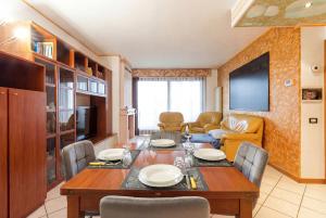 a dining room with a table and a couch at Dreamescape House in Alzano Lombardo