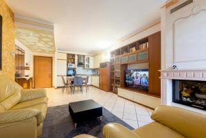 a living room with a couch and a tv at Dreamescape House in Alzano Lombardo