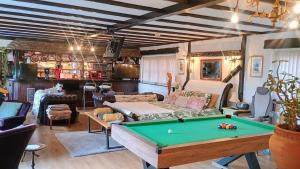 a living room with a pool table at Riverside Lodge Self-Catering Apartment in Peterborough