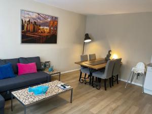 a living room with a couch and a table at Fisherman's House by Hofstad Hotels in Scheveningen