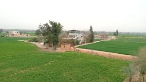 an aerial view of a large field with houses at Marwan Farmhouse Rooftop Apartment in Faraj Māḑī