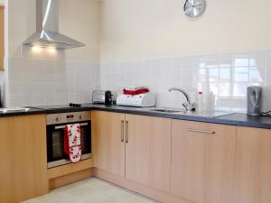 a kitchen with a sink and a counter top at The Dairy - Op3 in Carmarthen