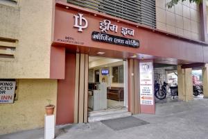 a building with a sign on the front of it at Hotel Dream Inn Thane in Thane