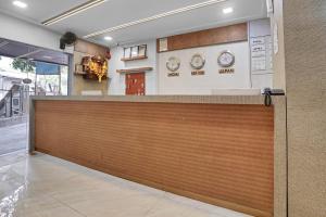 a garage door in a building with clocks on the wall at Hotel Dream Inn Thane in Thane