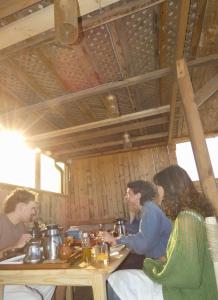 a group of people sitting at a table at hyle Surfhouse in Agadir