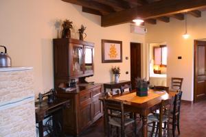 a kitchen with a wooden table and a dining room at CORTE STELLATA Il Grano Lodging in Bondeno