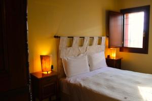 a bedroom with a bed with two lamps and a window at CORTE STELLATA Il Grano Lodging in Bondeno