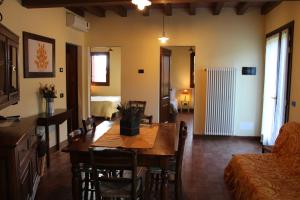 a living room with a table and a couch at CORTE STELLATA Il Grano Lodging in Bondeno +38 photos