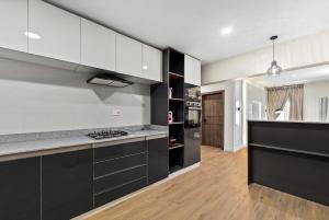 a kitchen with black and white cabinets and a counter at The Zenith Palace in Lekki