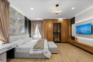 a bedroom with a large bed and a tv at The Zenith Palace in Lekki