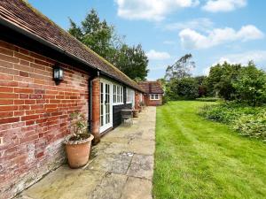 a brick house with a yard next to a building at Cottage 3 - Uk46609 in Broughton +13 photos