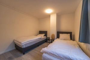 a room with two beds in a room at The Eau Rouge 600m from the entrance of the circuit in Stavelot