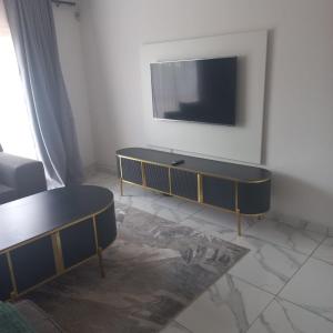 a living room with a tv on a wall at Comfort Retreat in Roodepoort