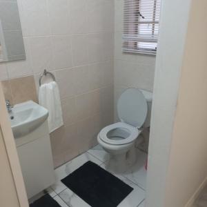 a bathroom with a toilet and a sink at Comfort Retreat in Roodepoort
