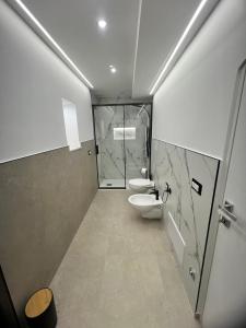 a bathroom with two toilets and a walk in shower at Buonaventura house2 in Triggiano +21 photos