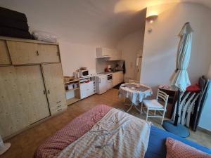a room with a kitchen with a bed and a table at Studio Vans in Les Vans