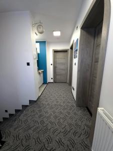 a hallway with a stairway with a door at Pokoje Sandra I in Łeba