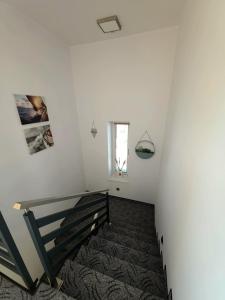 a staircase in a white room with a window at Pokoje Sandra I in Łeba