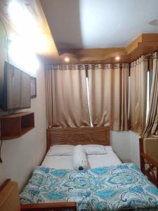 a small bed in a room with a window at Hotel Sikder-02 Residential in Dhaka