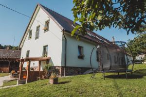 a house with a playground in front of it at Ubytování Třemešek in Šumperk