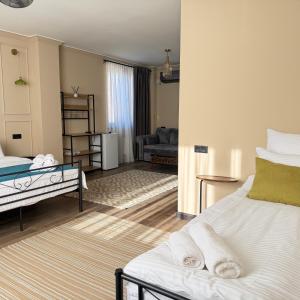 a bedroom with two beds and a living room at AMare guesthouse in Kapan