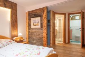 a bedroom with a bed and a bathroom at Roses Landhaus in Vorderhornbach
