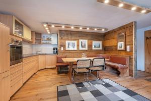 a kitchen with a table and chairs in a room at Roses Landhaus in Vorderhornbach