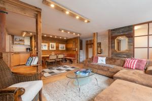 a living room with a couch and a table at Roses Landhaus in Vorderhornbach