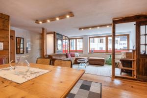 a living room with a table and a couch at Roses Landhaus in Vorderhornbach +17 photos