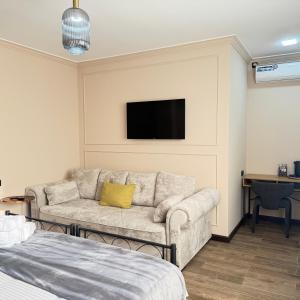 a living room with a couch and a flat screen tv at AMare guesthouse in Kapan
