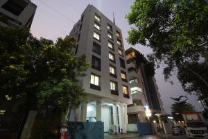 a tall building with lights on in a city at Hotel Palmera Inn in Pune