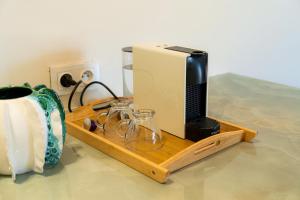 a television on a wooden tray with glasses and a vase at Maison soli Marrakech in Bou Khaoua