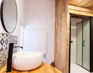 a bathroom with a white sink and a mirror at SURF HOSTEL BIARRITZ in Biarritz +85 photos