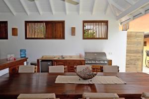 a living room with a table and a kitchen at Las Terrenas Front Beach And Garden Villa with private staff in Las Terrenas